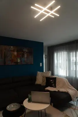 a living room with a couch and a laptop on a table at Luxury modern chic 1-bedroom apartment Athens City in Athens