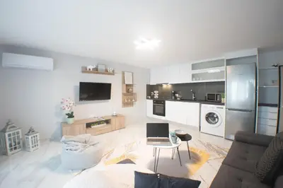 a living room with a couch and a laptop on a table at Luxury modern chic 1-bedroom apartment Athens City in Athens