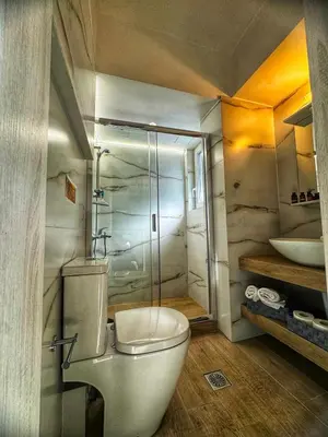 a bathroom with a toilet and a glass shower at Modern Athens Escape - Queen Bed & Metro Access in Athens
