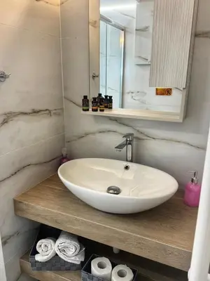 a bathroom with a sink and a mirror and towels at Modern Athens Escape - Queen Bed & Metro Access in Athens