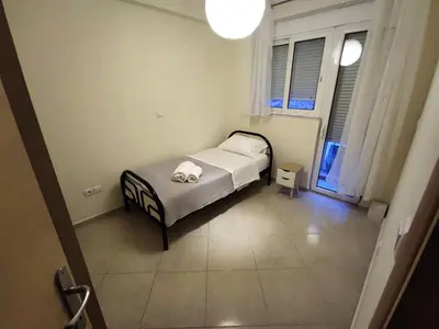a small bedroom with a bed in a room at Apartment, Piraeus in Piraeus