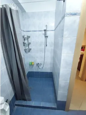 a bathroom with a shower with a shower curtain at Apartment, Piraeus in Piraeus