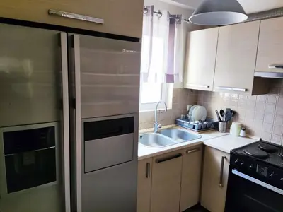 a kitchen with a stainless steel refrigerator and a sink at Apartment, Piraeus in Piraeus