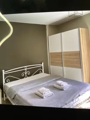 a bedroom with a bed with two towels on it at Παιδων ΣΤΟΥΝΤΙΟ in Athens