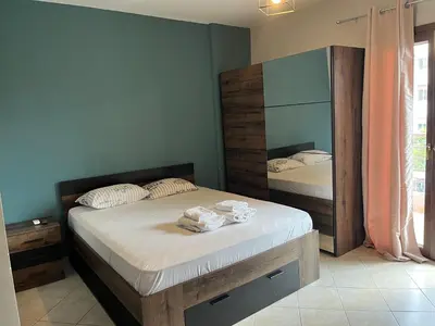 a bedroom with a bed with a large mirror at Παιδων ΣΤΟΥΝΤΙΟ in Athens
