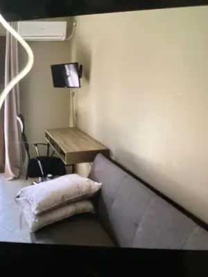 a room with a couch and a desk and a television at Παιδων ΣΤΟΥΝΤΙΟ in Athens