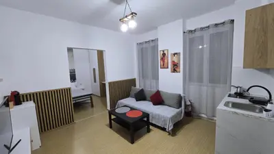 a living room with a couch and a sink at S&A apartments in Piraeus