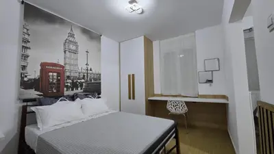 a bedroom with a bed and a picture of the city at S&A apartments in Piraeus