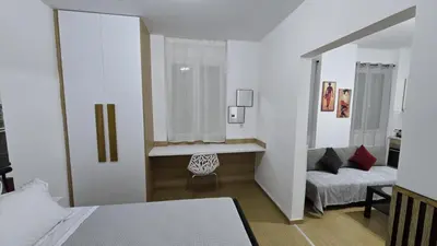 a bedroom with a bed and a chair and a couch at S&A apartments in Piraeus