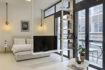 a living room with a large flat screen tv at Sci-Fi Themed Studio in Koukaki in Athens