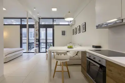 a kitchen with a white counter and a table at Sci-Fi Themed Studio in Koukaki in Athens