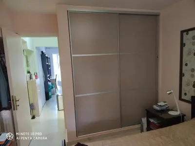 a large sliding closet door in a bedroom at beautiful beach apartment in Kavouri in Athens