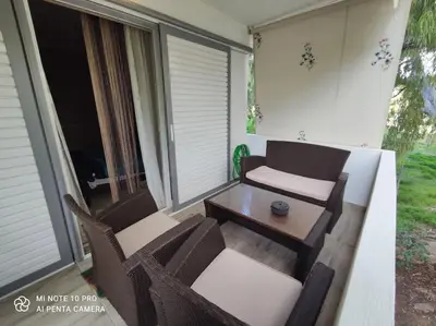 a patio with a table and chairs on a porch at beautiful beach apartment in Kavouri in Athens