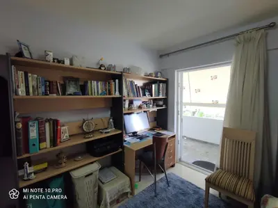 a room with a desk with a computer and a window at beautiful beach apartment in Kavouri in Athens