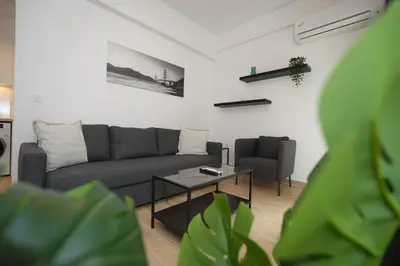 a living room with a couch and a table at Central 1 BDRM apartment, in Pangrati in Athens