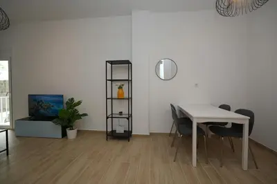 a dining room with a white table and chairs at Central 1 BDRM apartment, in Pangrati in Athens