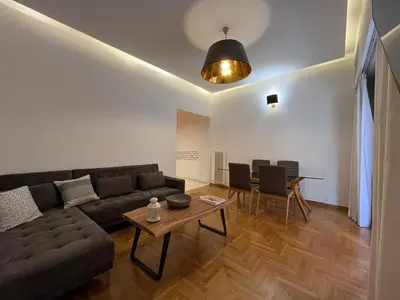 a living room with a couch and a table at Townheart House in Athens in Athens