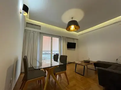 a living room with a glass table and a couch at Townheart House in Athens in Athens