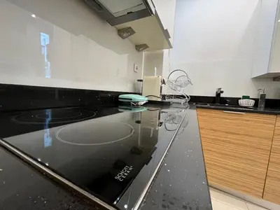 a kitchen with a black counter top in a kitchen at Townheart House in Athens in Athens