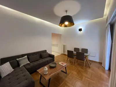 a living room with a couch and a table at Townheart House in Athens in Athens