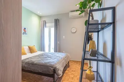 a bedroom with a bed and a glass ladder at Top Ten Studio in Athens