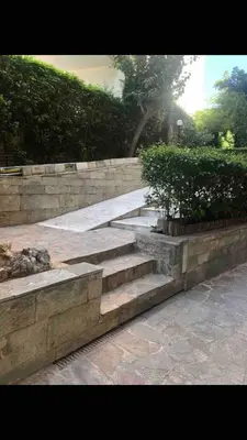 a set of stone steps with a plant on top at Home near Flisvos Marina in Athens