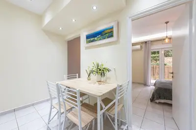 a dining room with a table and chairs at Home near Flisvos Marina in Athens