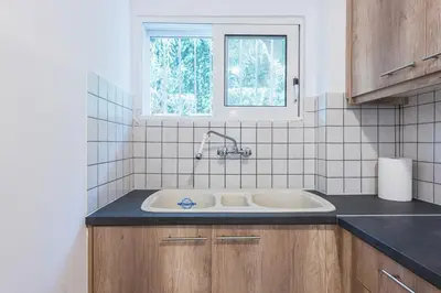 a kitchen with a sink and a window at Home near Flisvos Marina in Athens