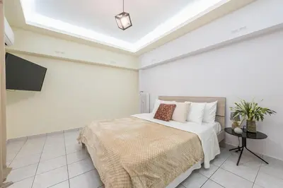 a bedroom with a bed and a television in it at Home near Flisvos Marina in Athens