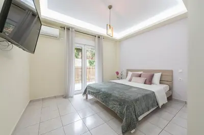 a bedroom with a bed and a flat screen tv at Home near Flisvos Marina in Athens