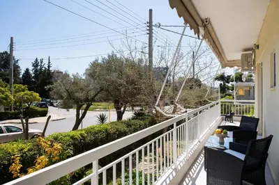 a balcony of a house with a table and chairs at Glyfada Luxury Suite by First Class Properties in Athens