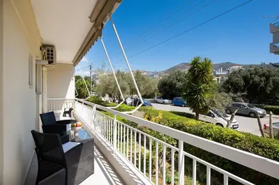 a balcony with chairs and a view of a street at Glyfada Luxury Suite by First Class Properties in Athens