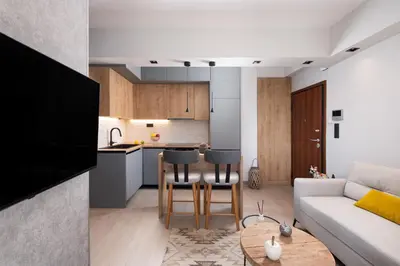 a living room and kitchen with a couch and a table at Glyfada Luxury Suite by First Class Properties in Athens