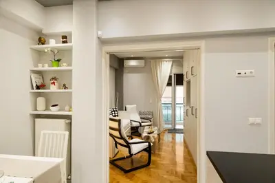 a living room with two chairs and a table at Athenian Escape - Located near the heart of Athens in Athens