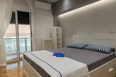a bedroom with a bed with a blue box on it at Athenian Escape - Located near the heart of Athens in Athens