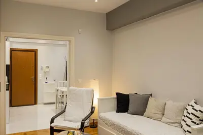 a living room with a couch and a chair at Athenian Escape - Located near the heart of Athens in Athens