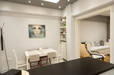 a kitchen and dining room with a table and chairs at Athenian Escape - Located near the heart of Athens in Athens
