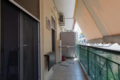 an empty balcony of a building with a window at Athenian Escape - Located near the heart of Athens in Athens