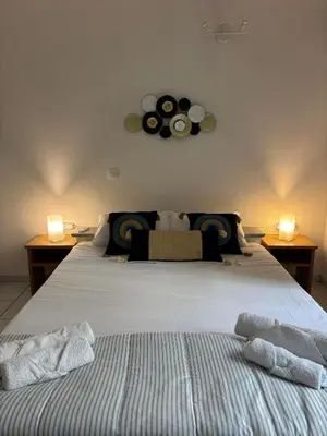 a bedroom with two beds and two lights on the wall at Cozy apartment by Athens in Athens