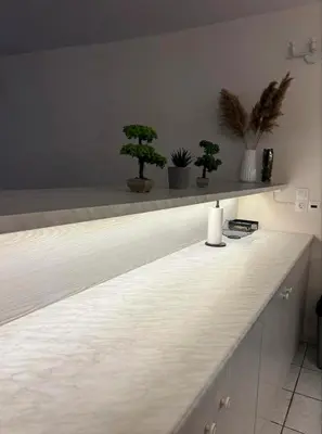 a counter with three potted trees on top of it at Cozy apartment by Athens in Athens