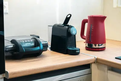 a toaster and a coffee maker on a kitchen counter at AMAZING PENTHOUSE FOR SIX person in Athens