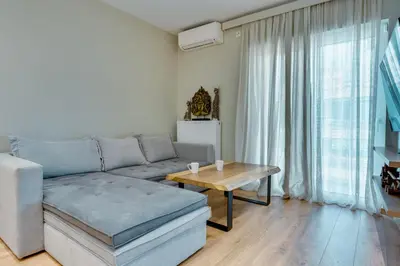 a living room with a couch and a table at AMAZING PENTHOUSE FOR SIX person in Athens