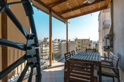 a balcony with a table and chairs on a balcony at AMAZING PENTHOUSE FOR SIX person in Athens