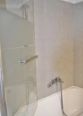a bathroom with a shower and a tub and a sink at Central Athenian Maison, with Acropolis Views in Athens