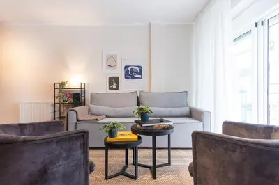 a living room with a couch and a table at Cozy Athenian Hideaway in the heart of Pangrati in Athens