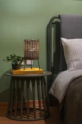 a table with a lamp on it next to a bed at Cozy Athenian Hideaway in the heart of Pangrati in Athens