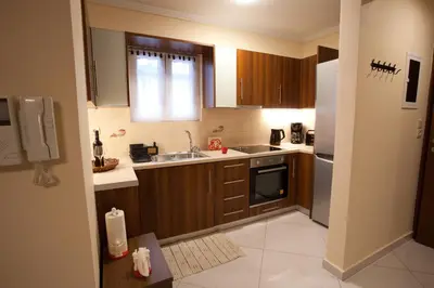 a small kitchen with a sink and a refrigerator at Lovely Nest Piraeus Premium in Piraeus