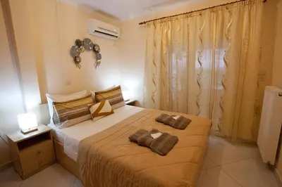 a bedroom with a bed with two pillows on it at Lovely Nest Piraeus Premium in Piraeus