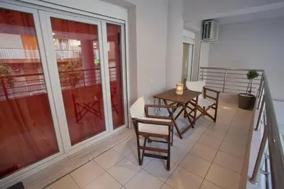 a balcony with a table and chairs in a room at Lovely Nest Piraeus Premium in Piraeus