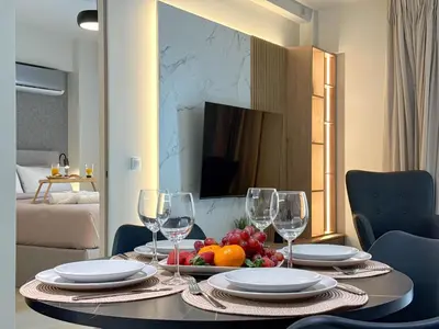 a dining room table with a bowl of fruit and wine glasses at AirRent Apartments 4 Jacuzzi Suite in Athens